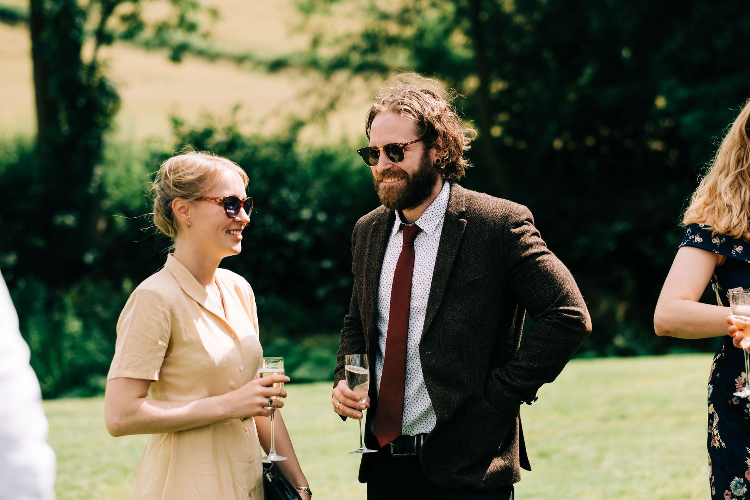 Guests mingling and celebrating at an elegant outdoor garden wedding reception.