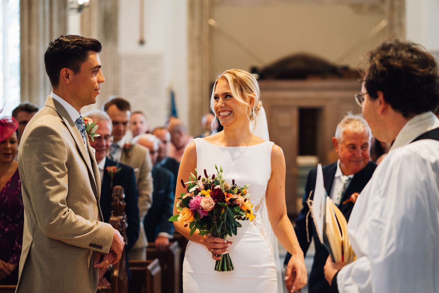 Couple exchanges vows at the altar during an intimate church wedding ceremony.