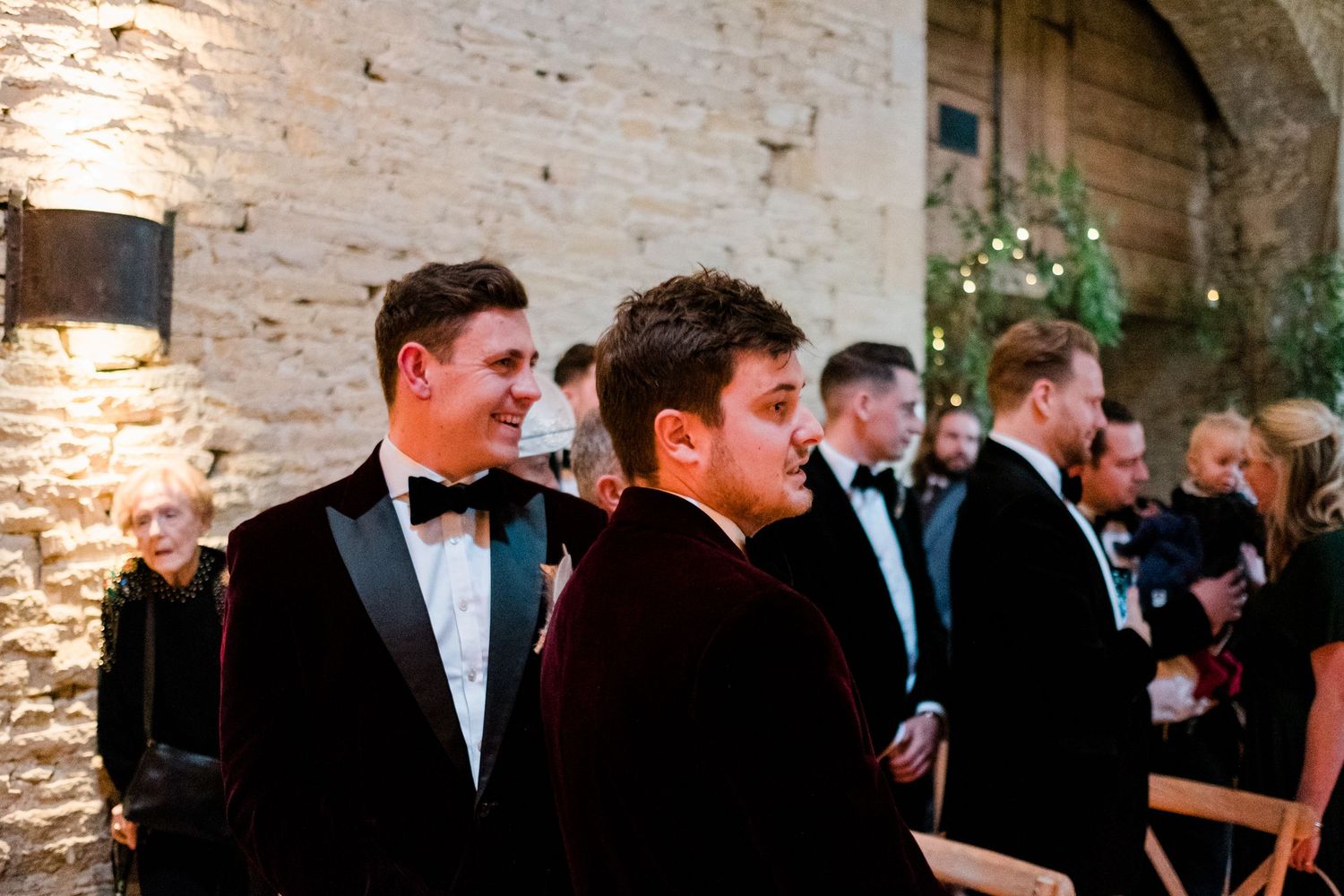 Wedding celebration candid moments captured in historic stone building interior.