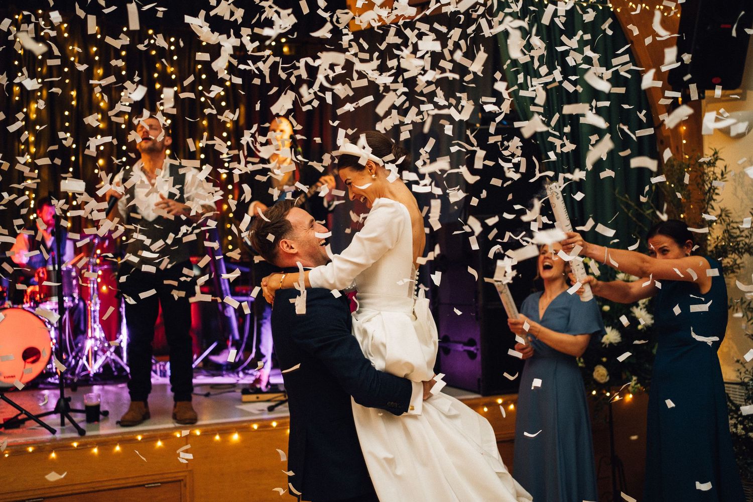 Wedding celebration sequence with confetti being thrown over dancing couples at an evening reception.