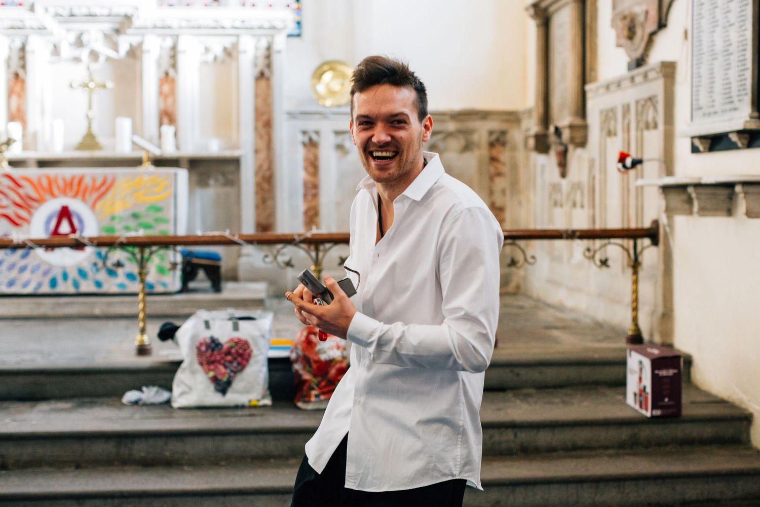 Candid moments of laughter and joy captured in a white-walled hallway setting.