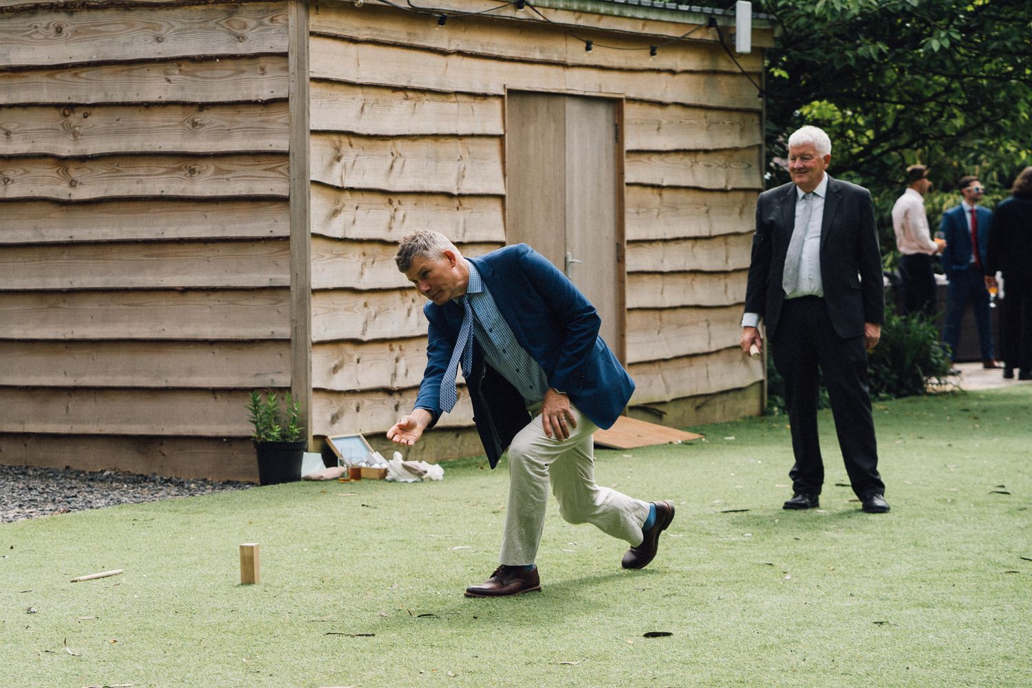 People enjoying outdoor lawn games at a casual gathering.