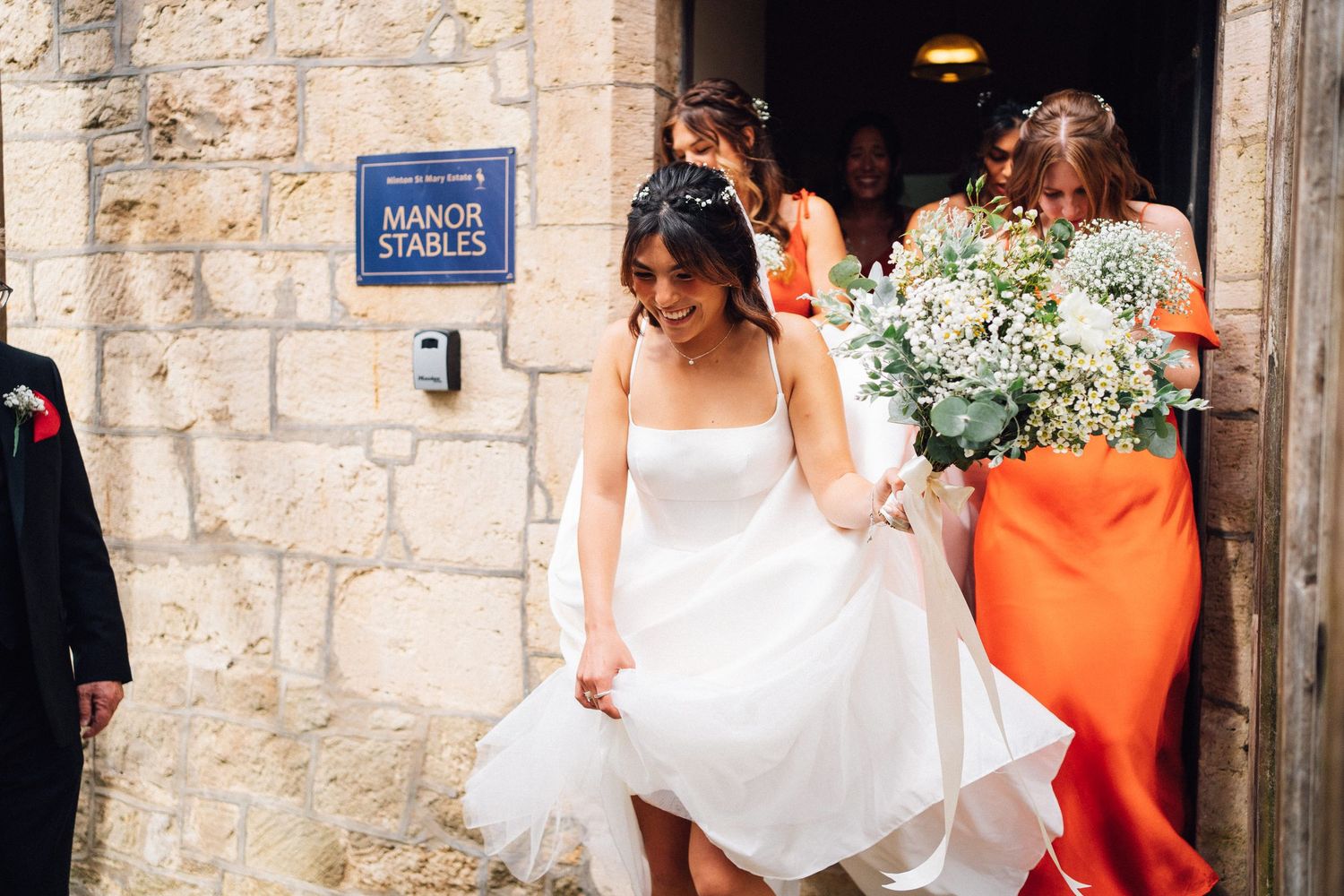 Stone church entrance decorated for a wedding ceremony with floral arrangements.
