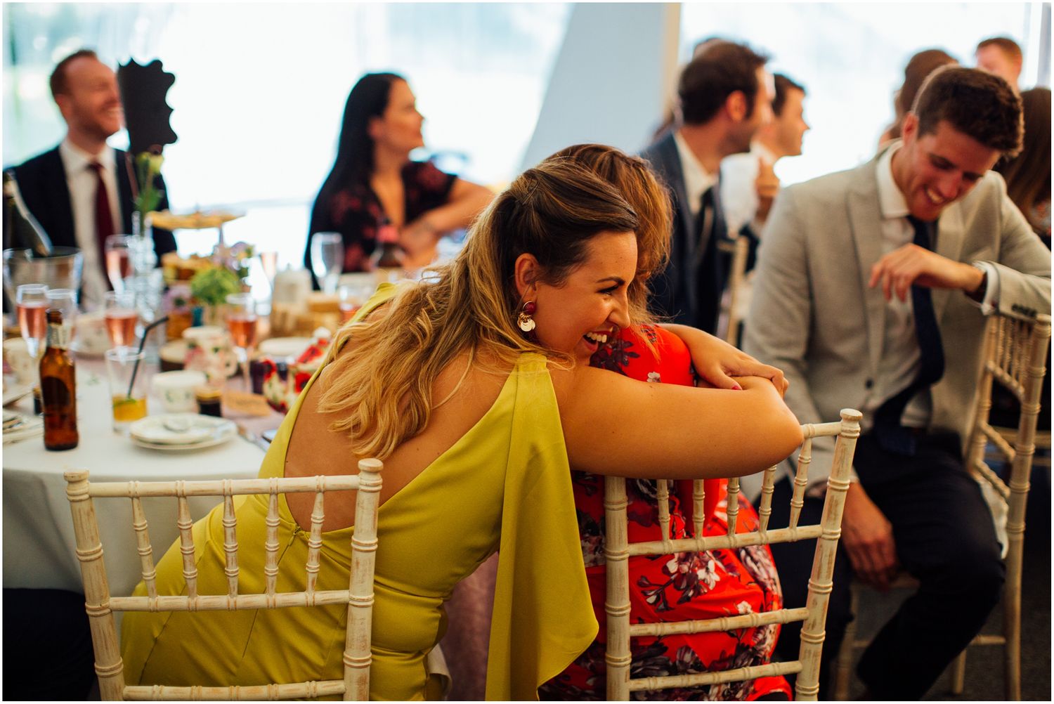 Wedding guests seated at tables during reception dinner.