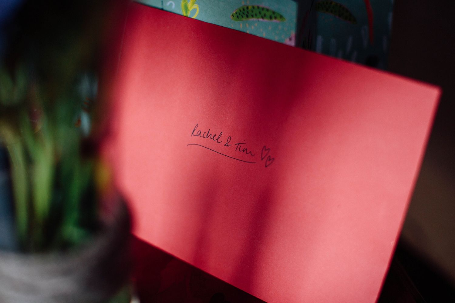 A red-tinted close-up shot of text on paper or card.