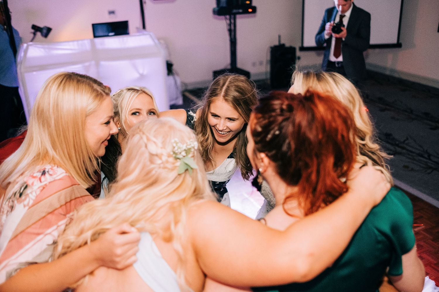 Group of wedding guests sharing an emotional moment during the reception.