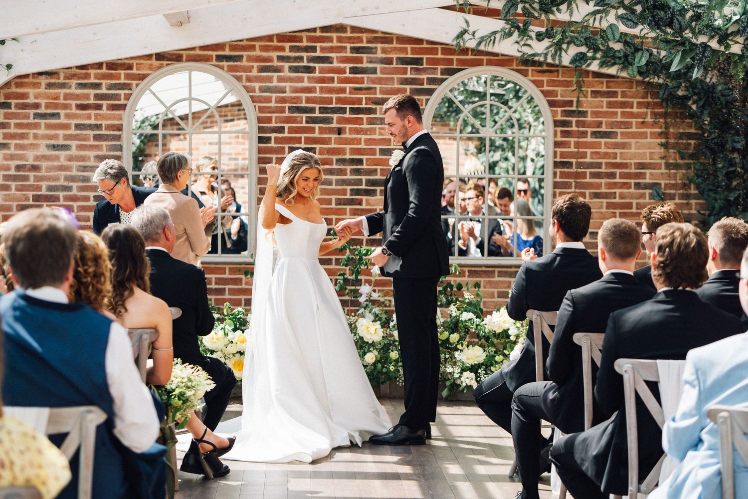 A wedding ceremony collage showing various moments at a brick venue with guests and celebrations throughout the day.