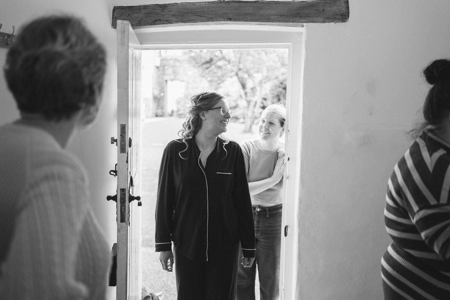 A series of black and white candid photographs showing people in casual indoor settings.