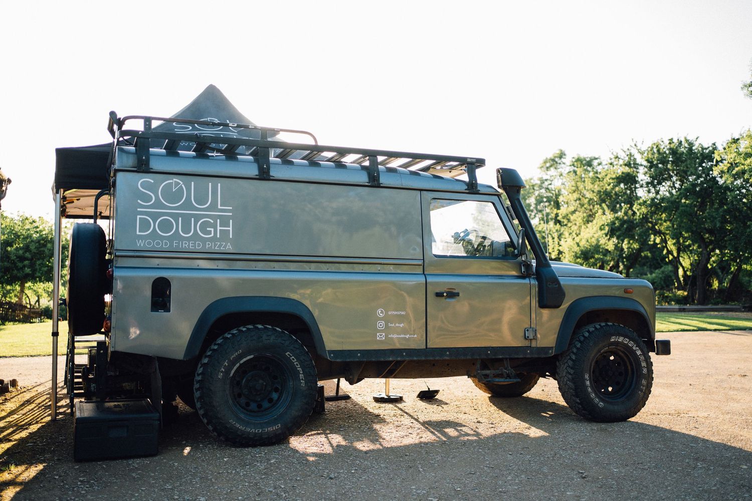 Vintage food truck with 'Soul Dough' branding parked outdoors on a sunny day.