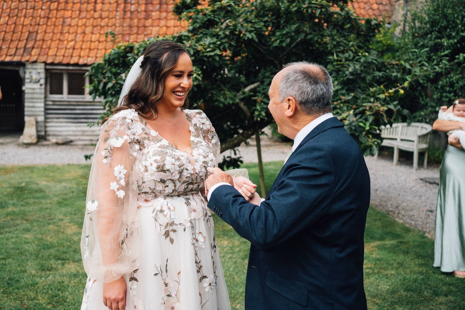 A tender first look moment between a couple during their outdoor garden wedding ceremony.