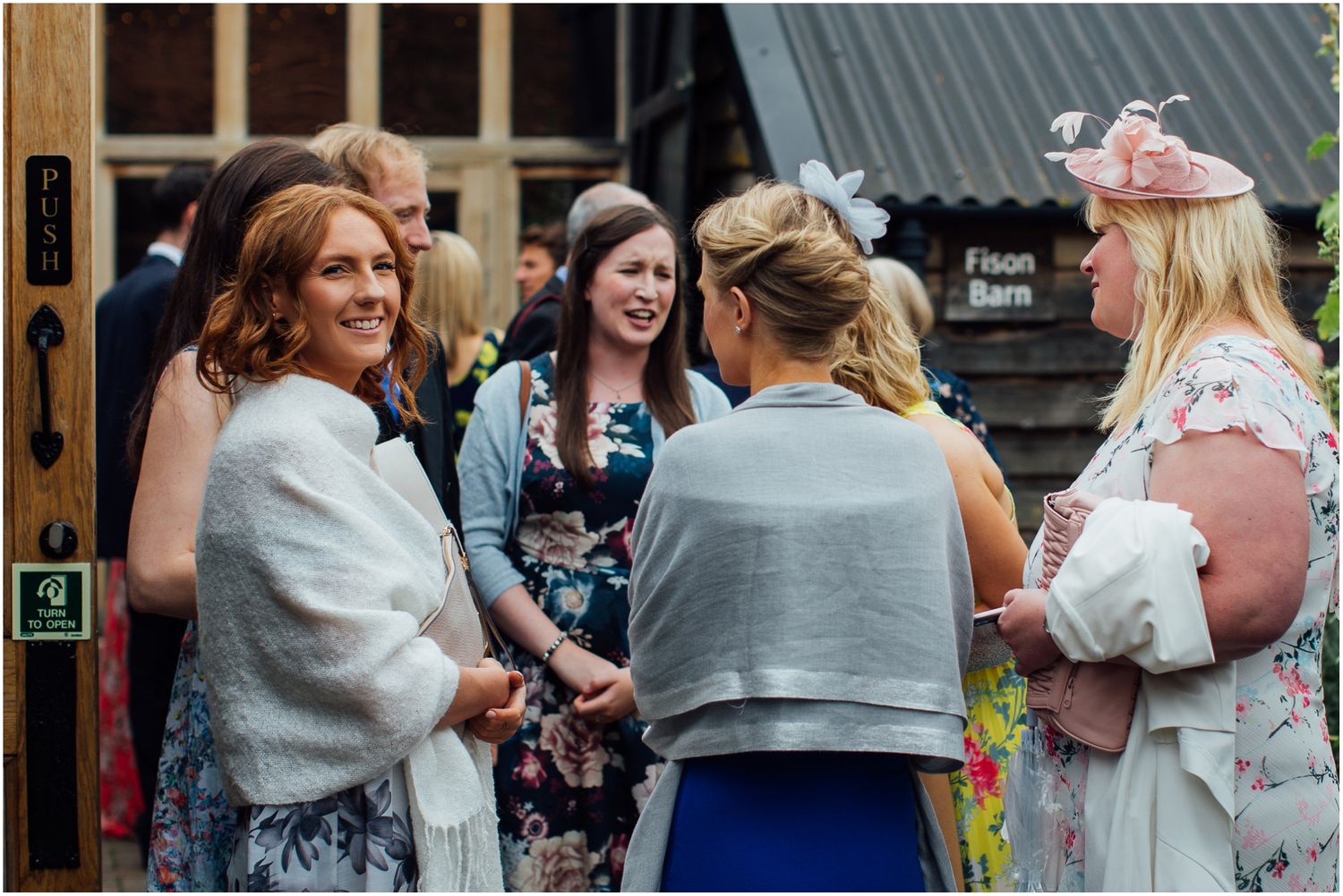 Wedding guests chatting and mingling during an outdoor reception event.