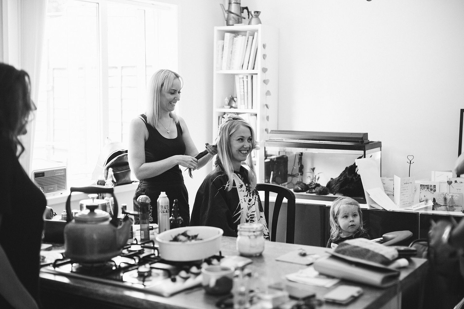 Black and white photo of wedding day preparations in a bright room.