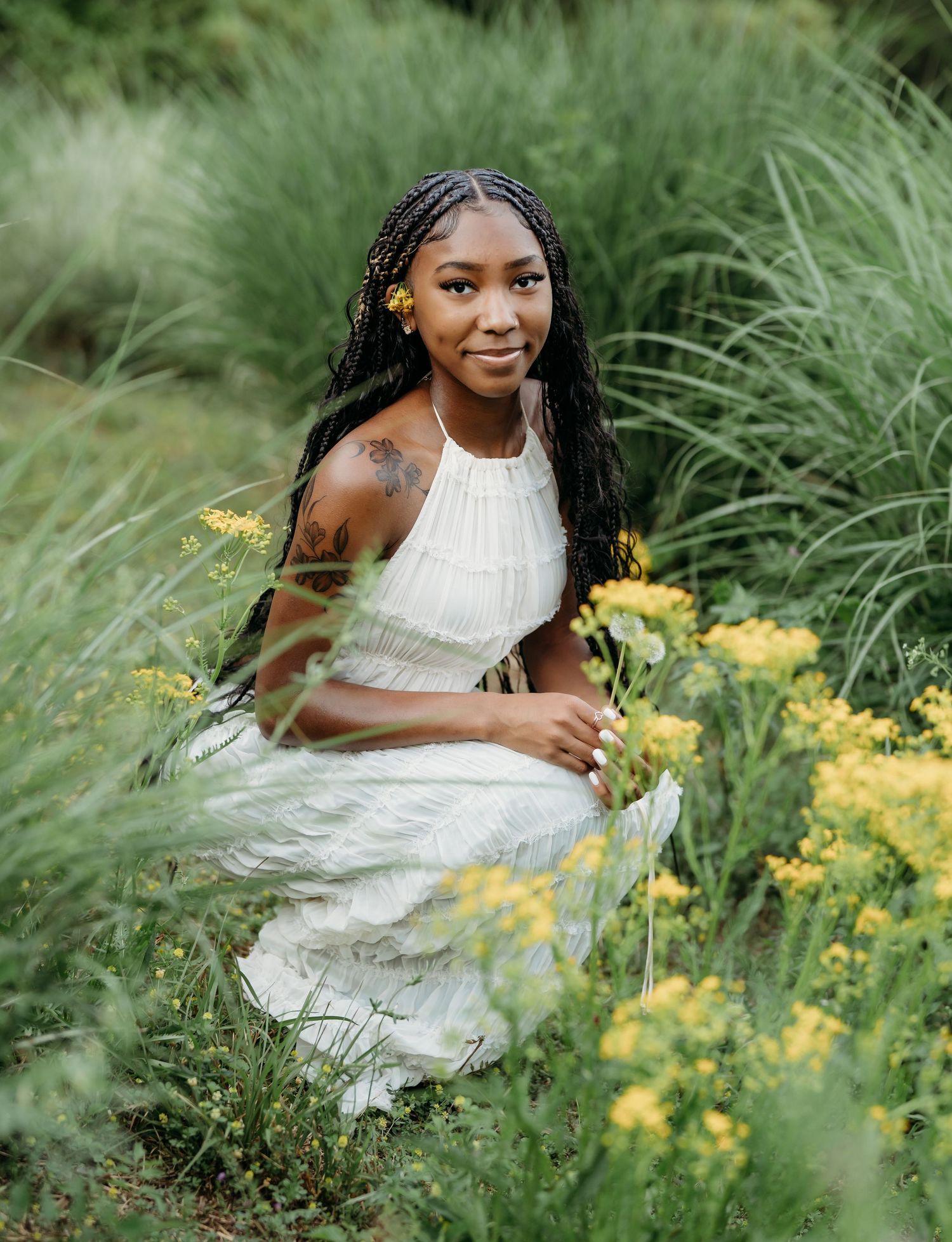 A cheerful scene in nature with tall grass, yellow wildflowers, and a white summer dress on a sunny day.