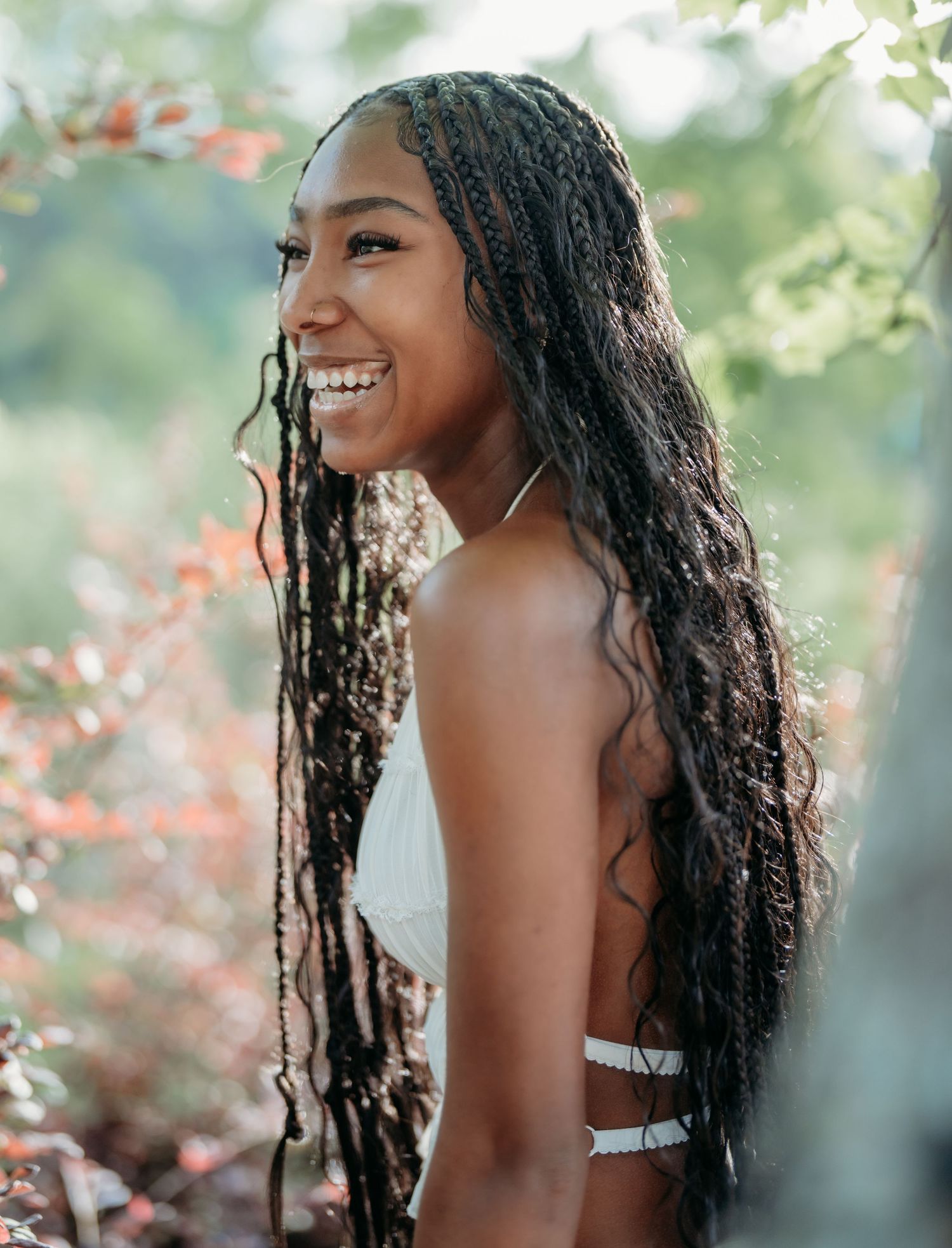 Portrait series showing joyful expressions and natural hair against a soft outdoor background with bokeh lighting effects.