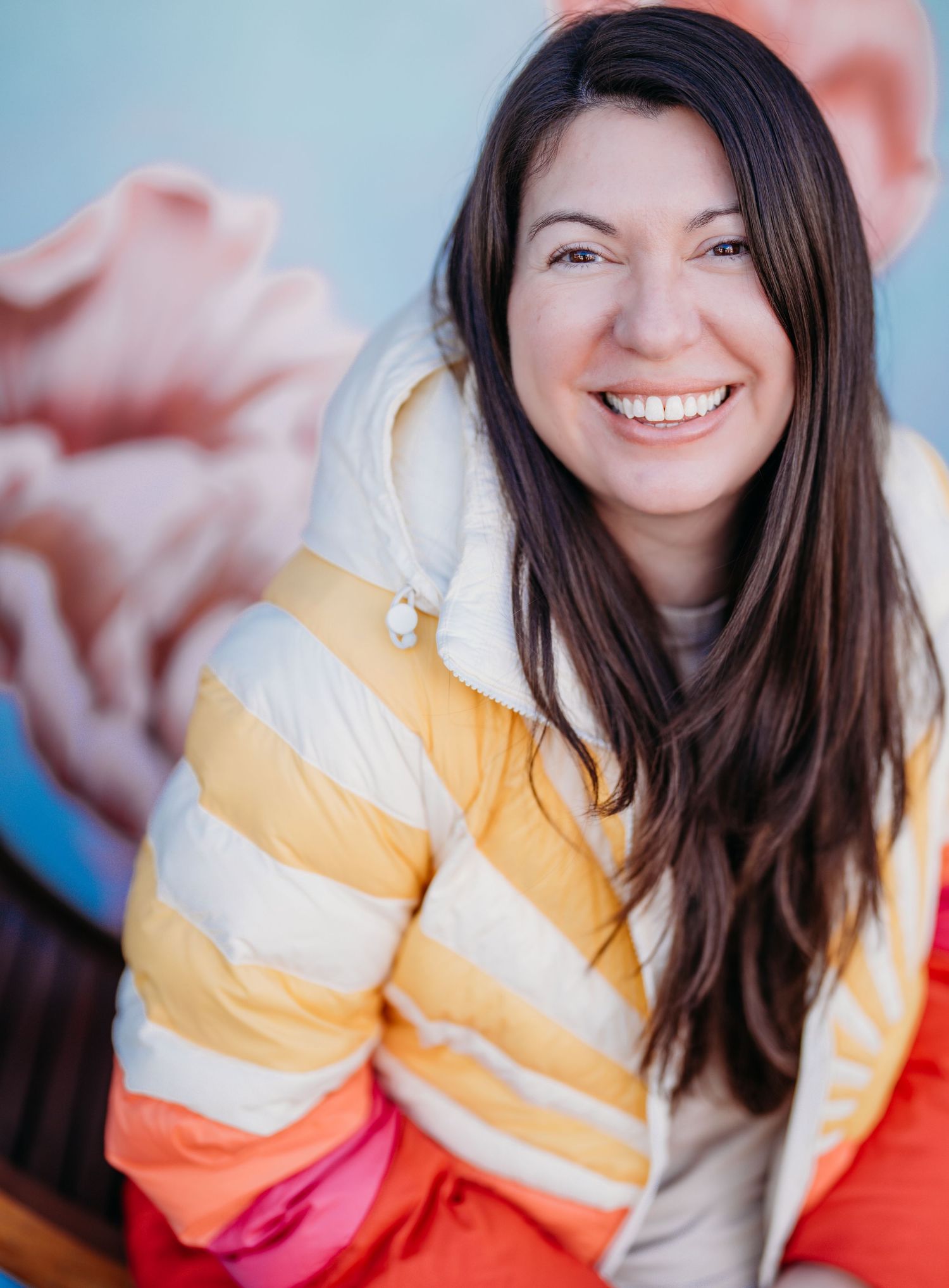 A series of candid portraits showing someone in a yellow and white striped sweater against a blurred pink background.