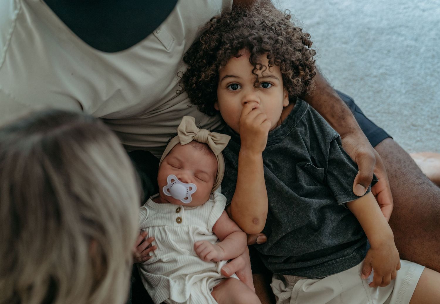 Natural lifestyle family portraits showing authentic moments of connection indoors.
