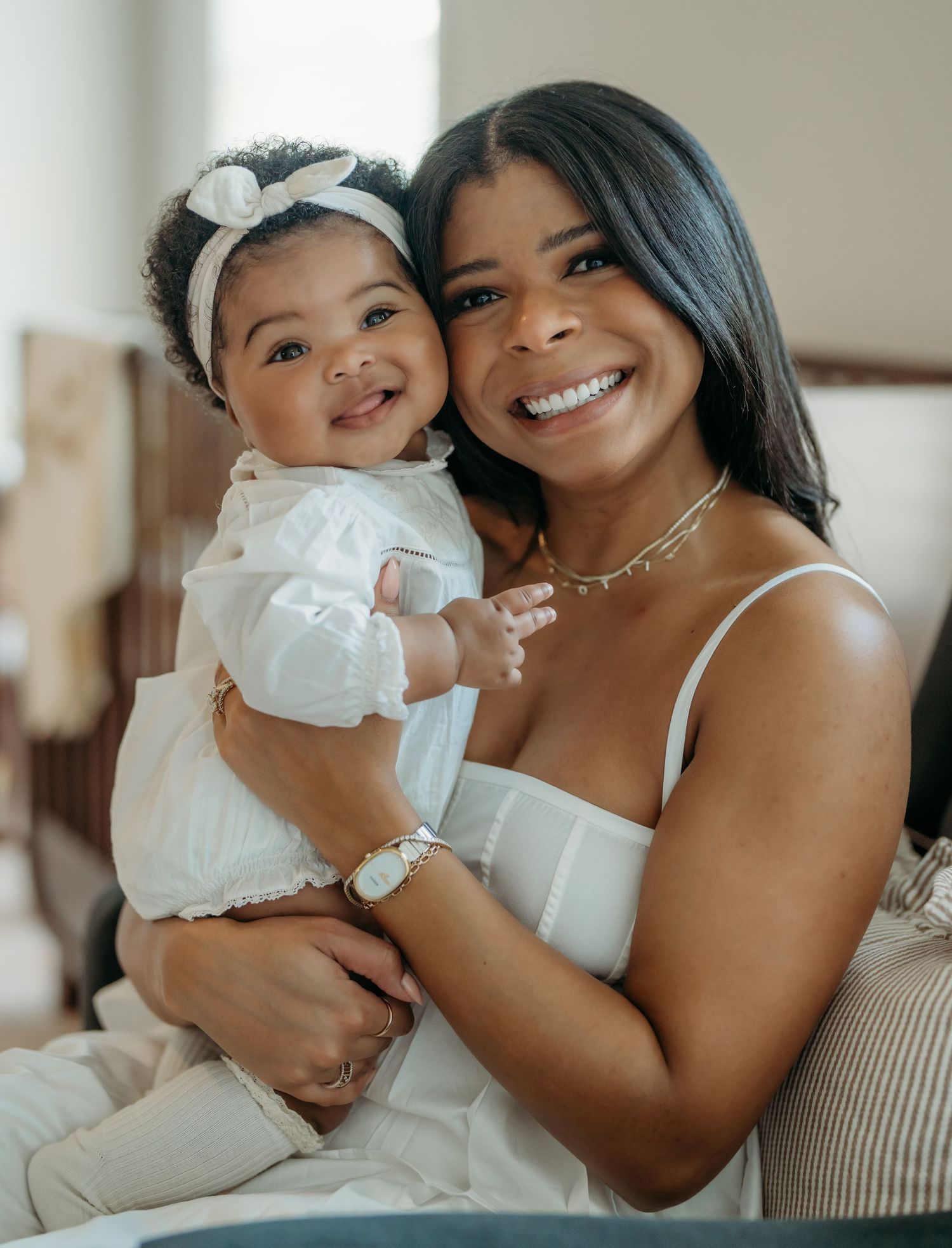 A mother and baby share tender moments in a series of intimate indoor portraits with soft natural lighting.
