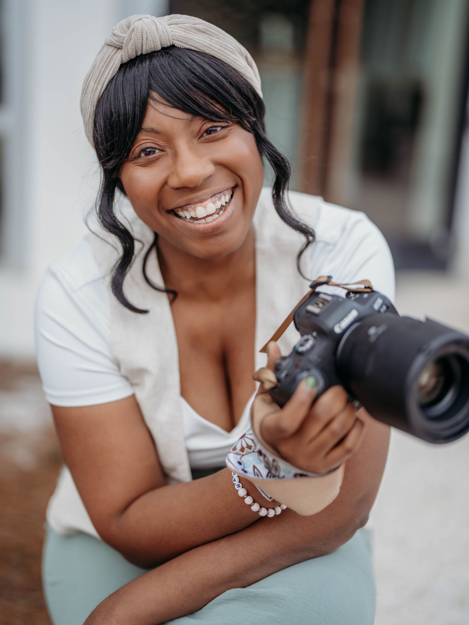 A smiling person in a white t-shirt poses playfully in a series of four candid portrait photographs.