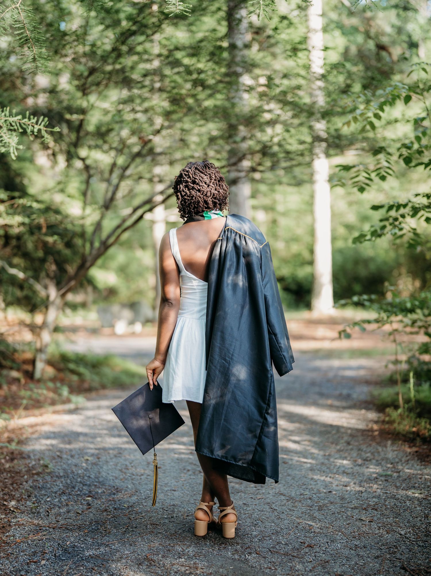 A sequence of four photos shows someone walking down a tree-lined gravel path carrying a blue jacket and walking stick.