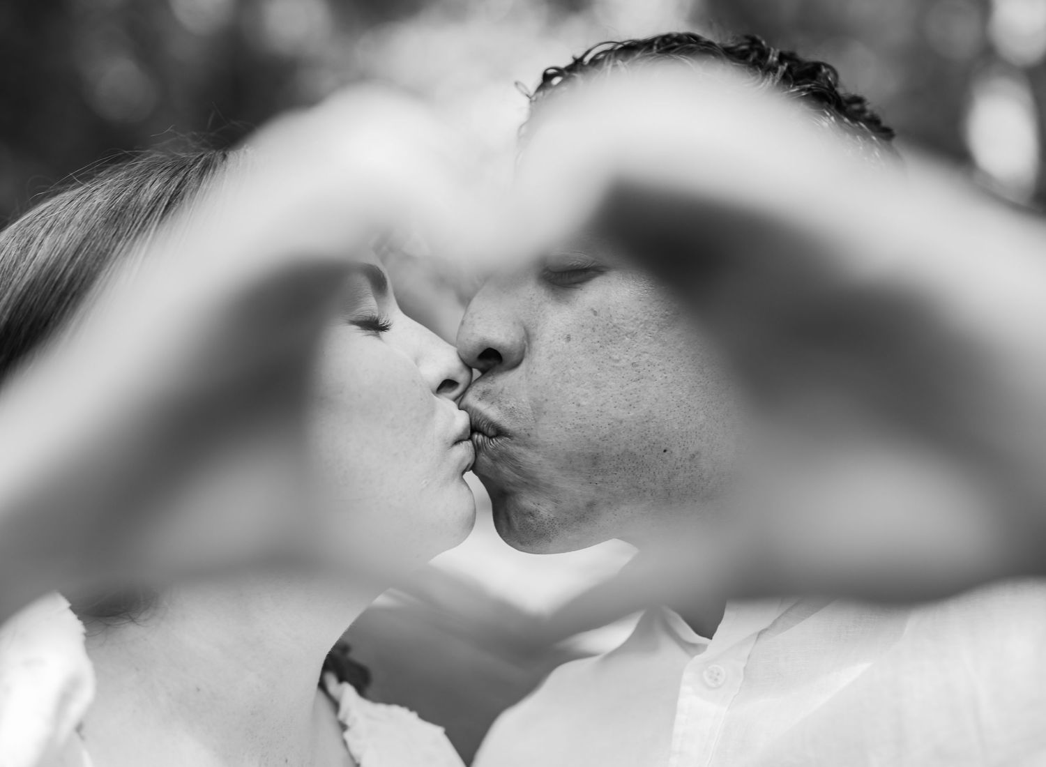 An artistic black and white photo series capturing intimate close-up romantic moments between a couple.