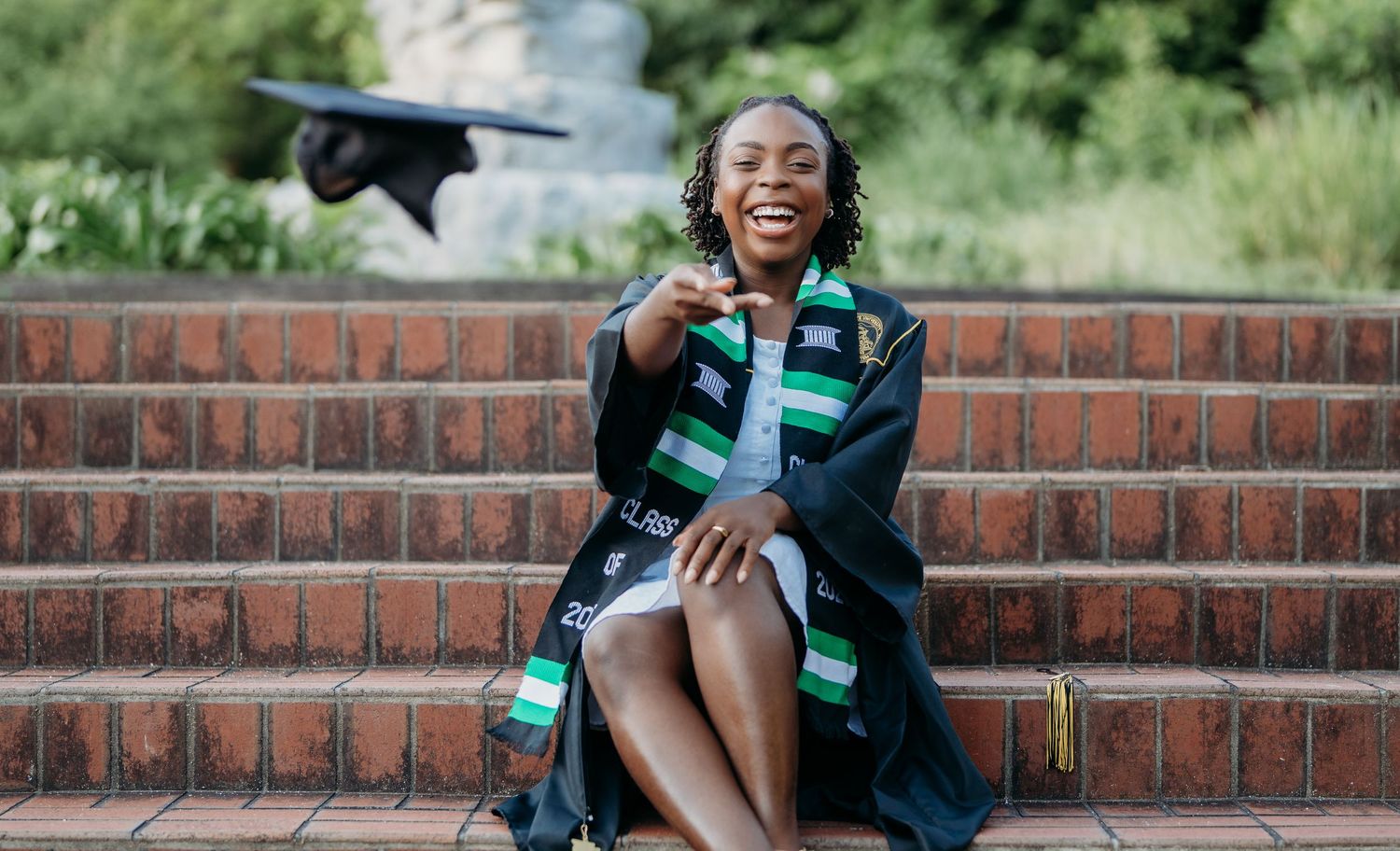 A collage of outdoor graduation photos shows someone sitting and posing on brick steps in academic regalia.