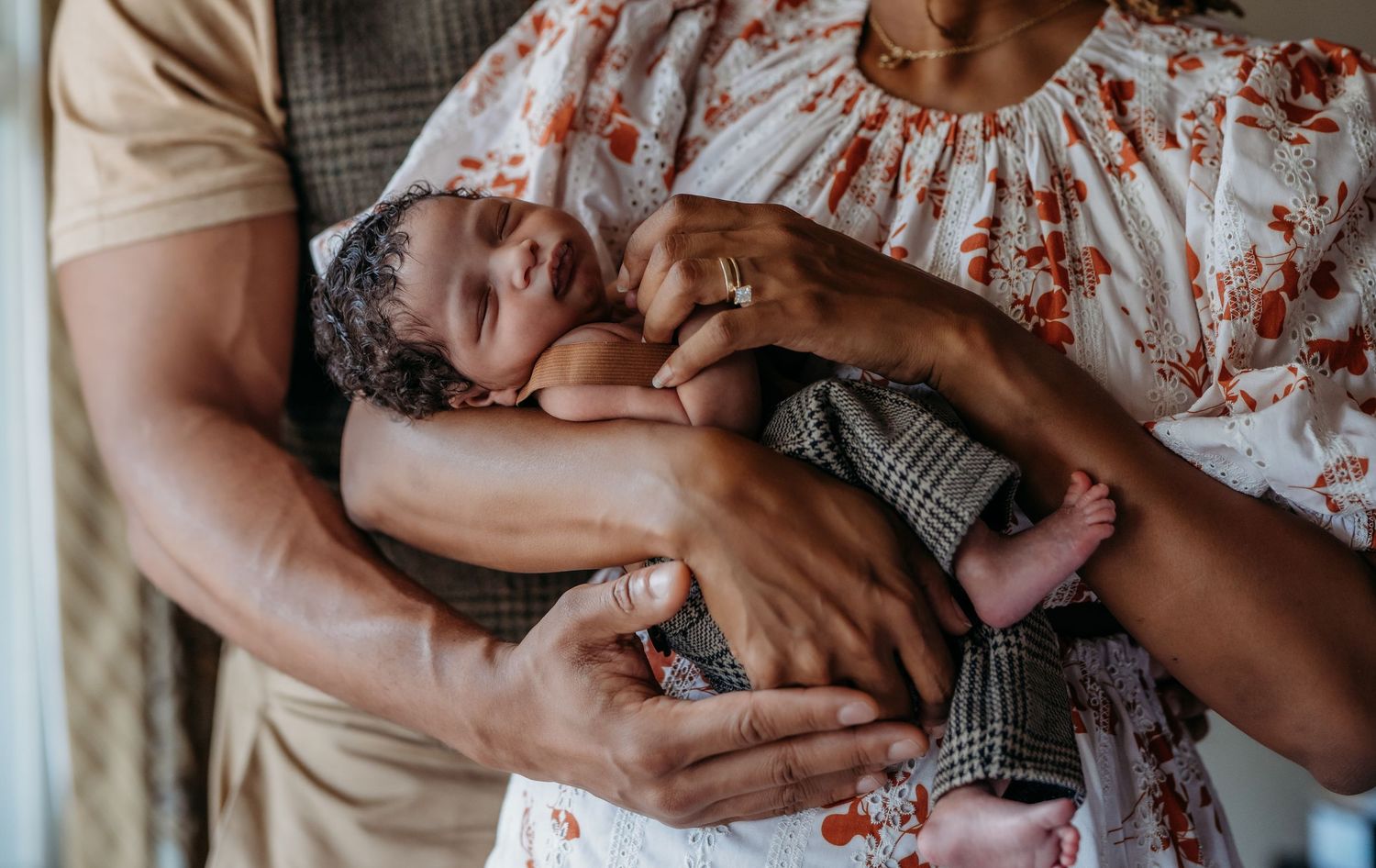 A series of tender moments between parent and newborn baby showing gentle embraces and skin-to-skin contact.