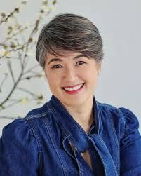 Collection of professional portraits featuring a person in a navy blue outfit.