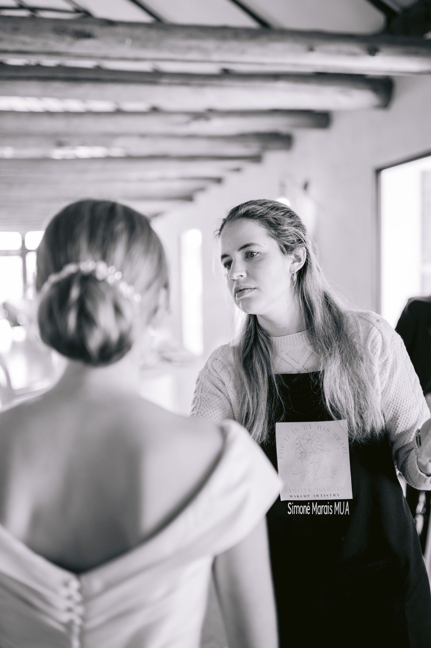 A series of black and white artistic photographs showing intimate moments during a wedding preparation.