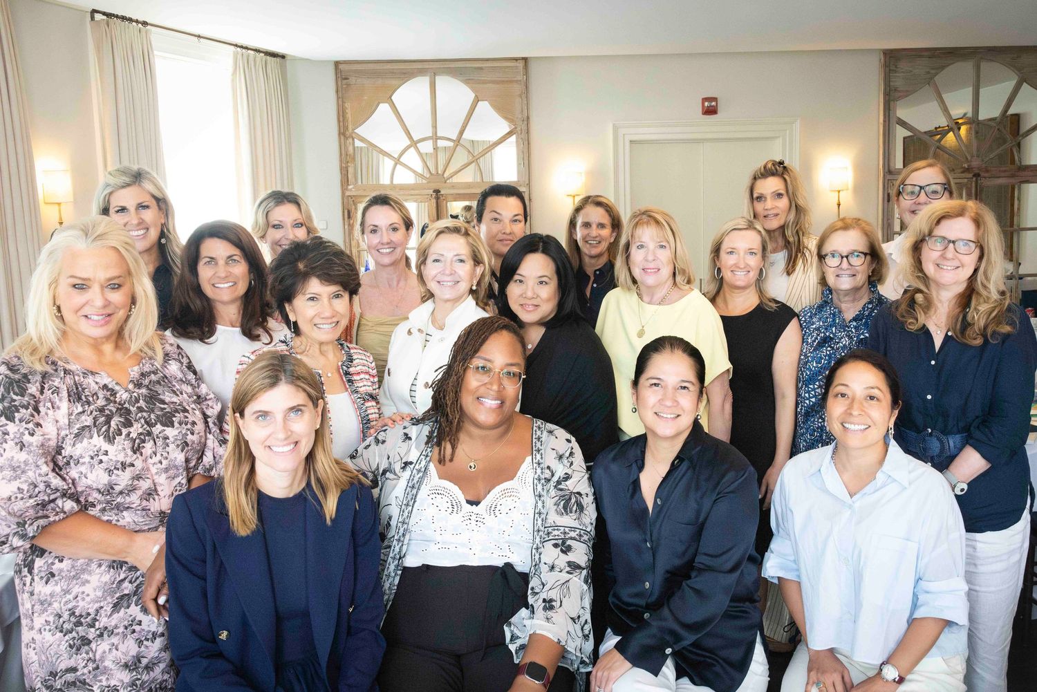 A group of medical or business professionals standing together in an office for a team photo.