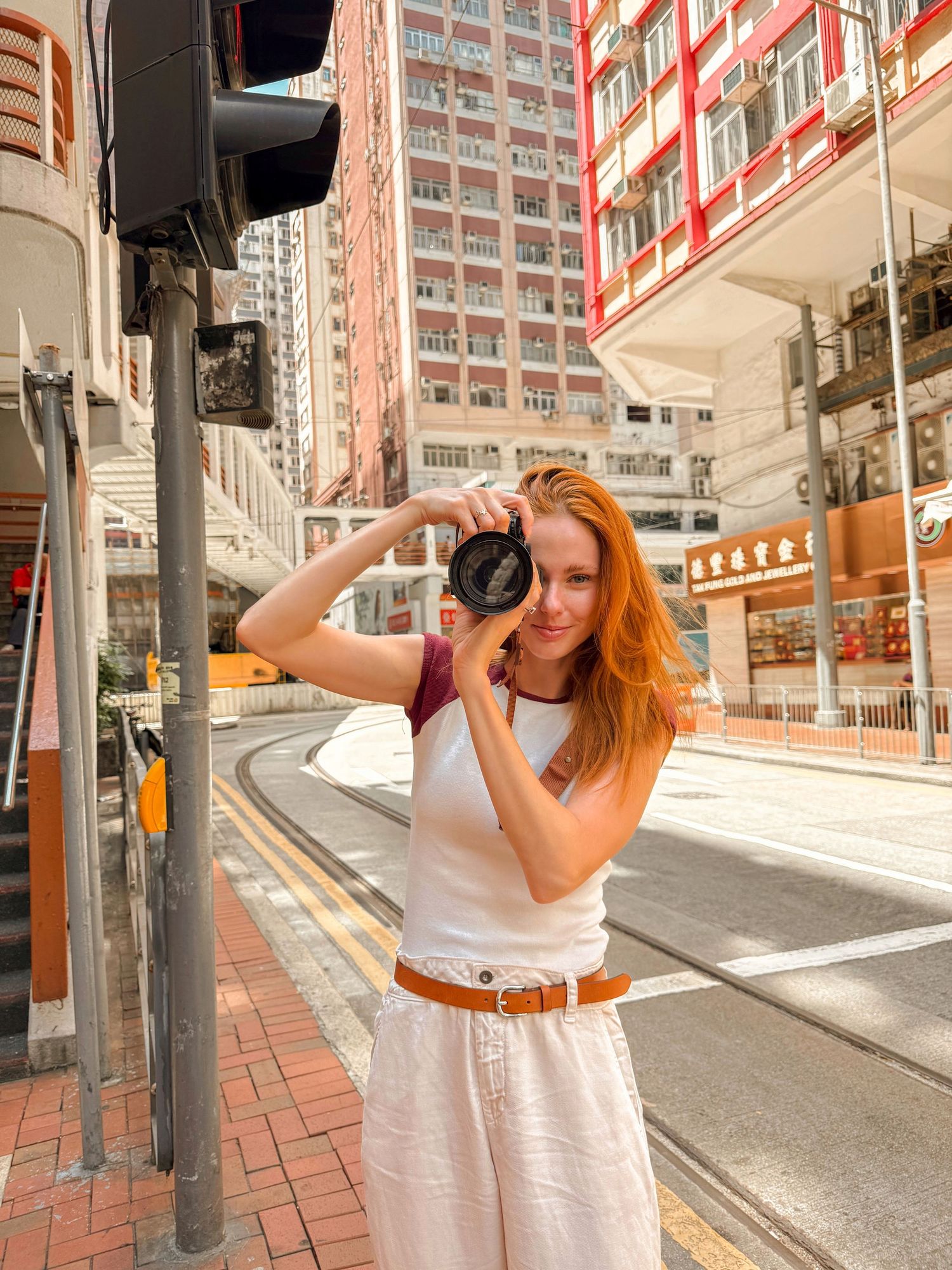 Alyssa Campanella taking photos in urban Hong Kong setting.