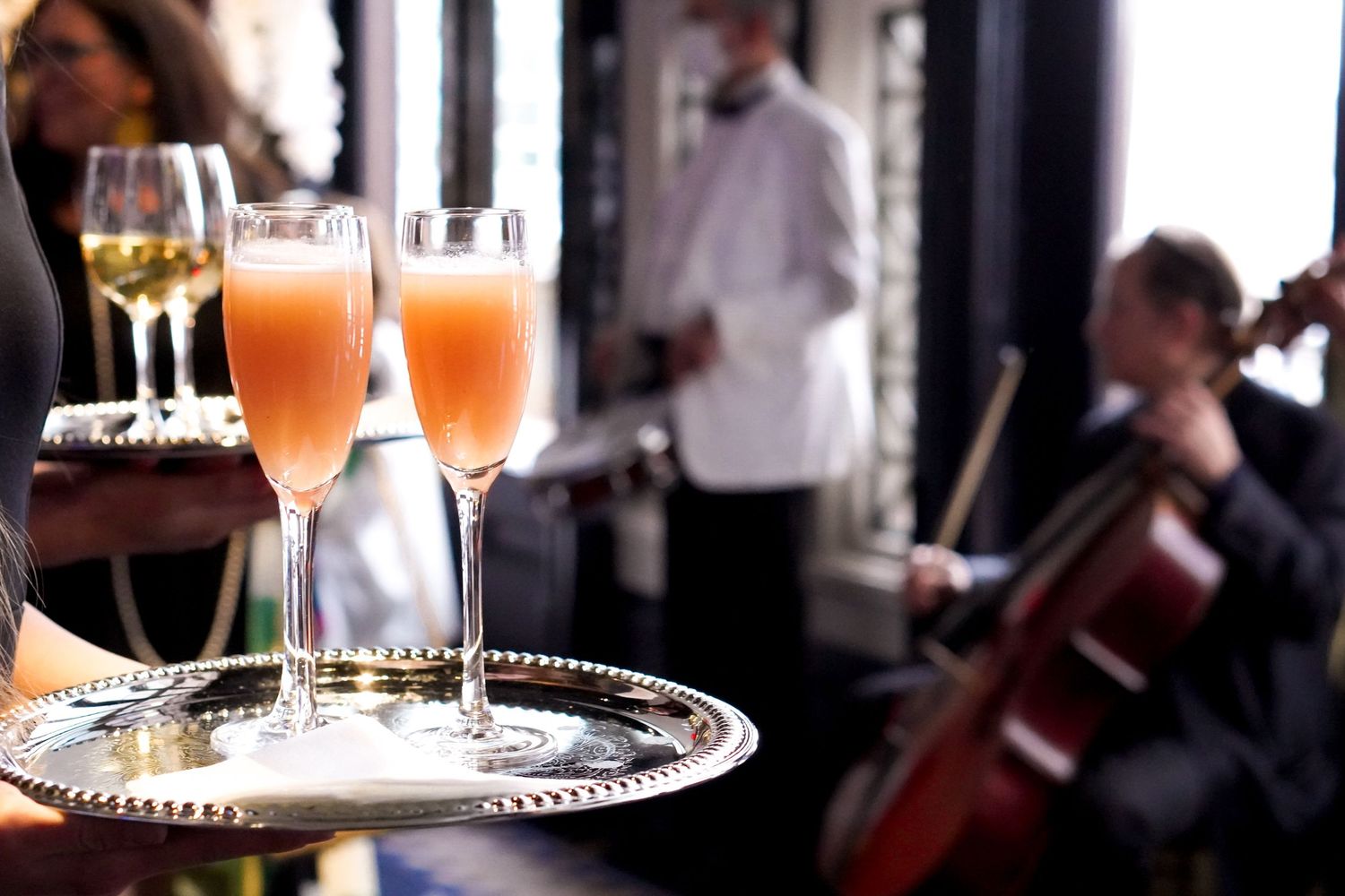 Elegant cocktail setup with champagne flutes and ambient lighting at an upscale event.