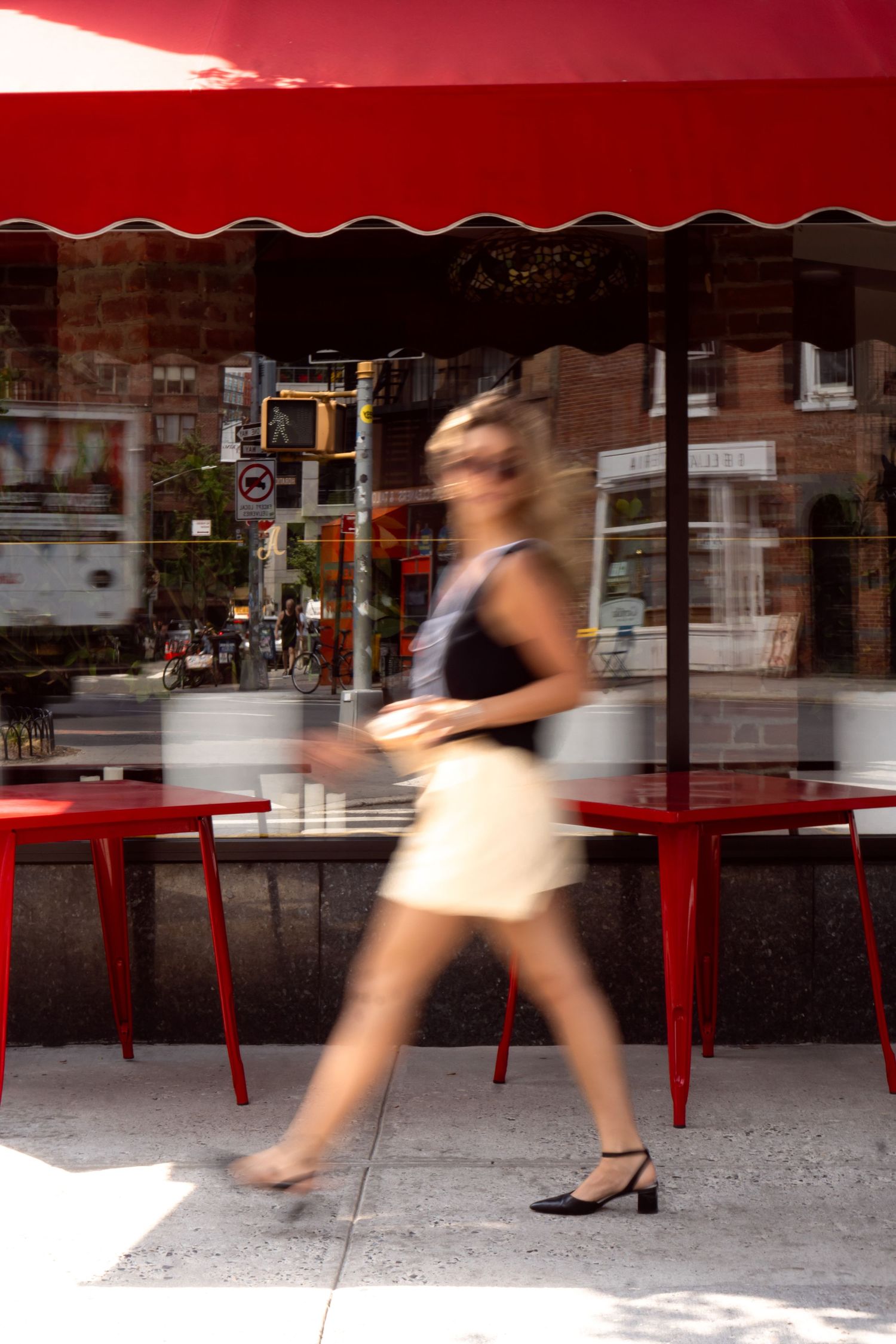 Street photography sequence showing blurred motion of walking past shop windows.