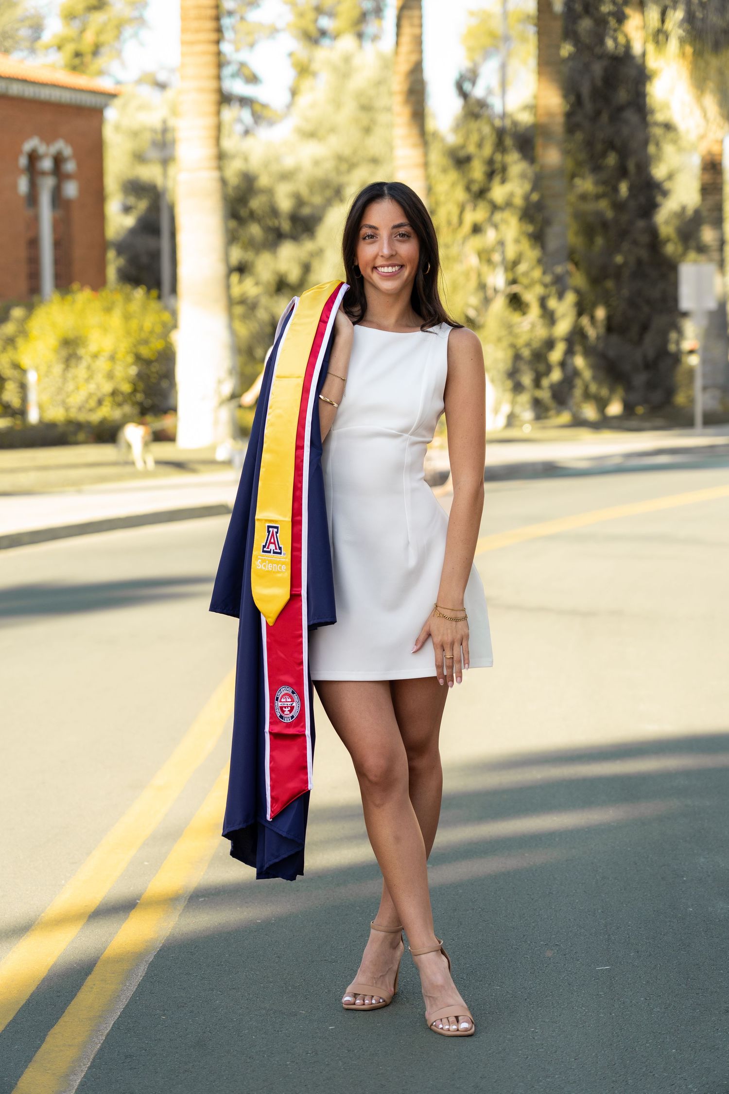 Graduation portraits on street with University of Arizona stoles and casual attire.