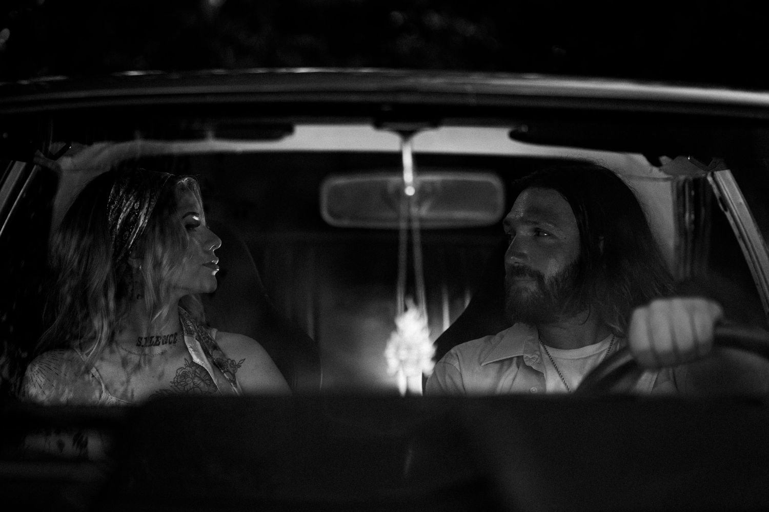 Dramatic black and white sequence of car interior shots at night.