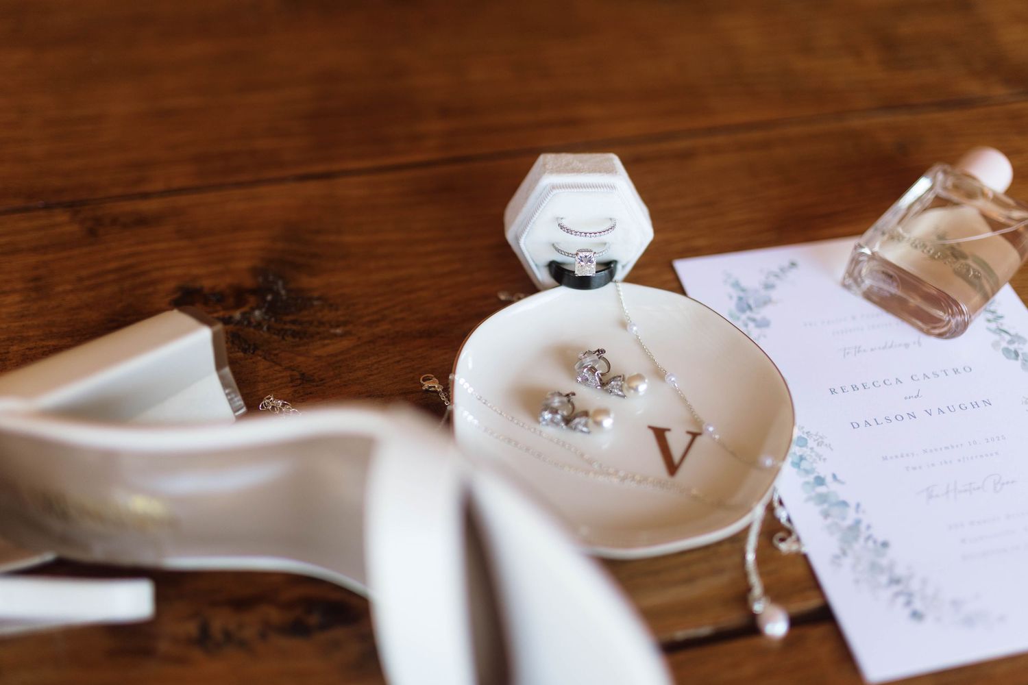 Elegant wedding rings displayed on a white surface with handwritten text and delicate decor details.