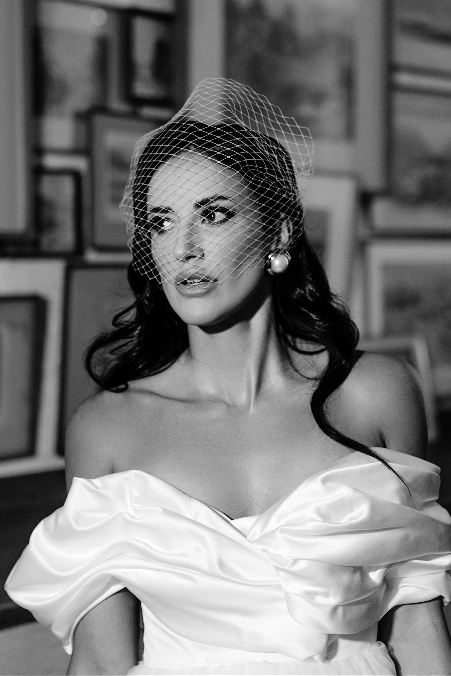 A black and white photo series showing a person in an elegant off-shoulder white dress posing gracefully.