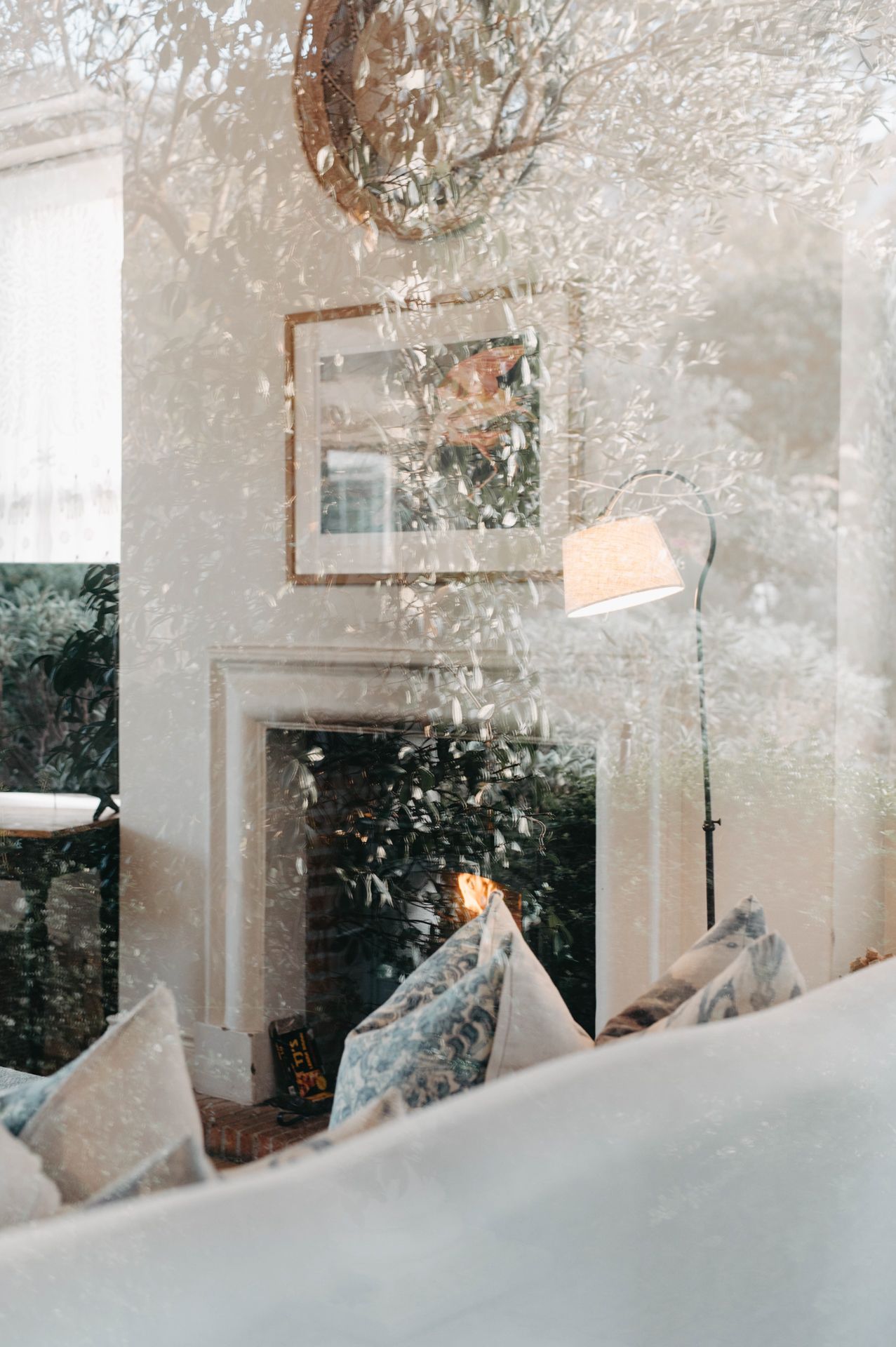 Sunlight streams through frosted windows creating a dreamy, ethereal atmosphere with white cushions on a window seat.
