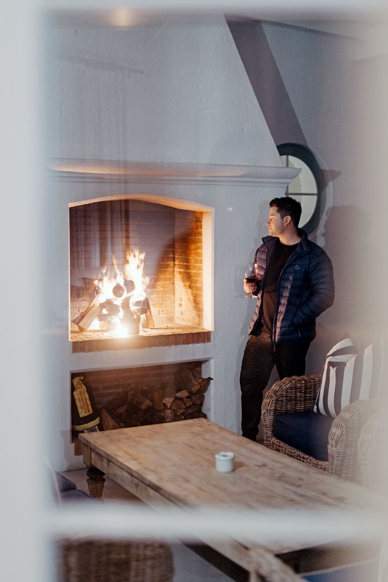 Sequence of photos showing a person photographing a burning fireplace with a camera and tripod setup.