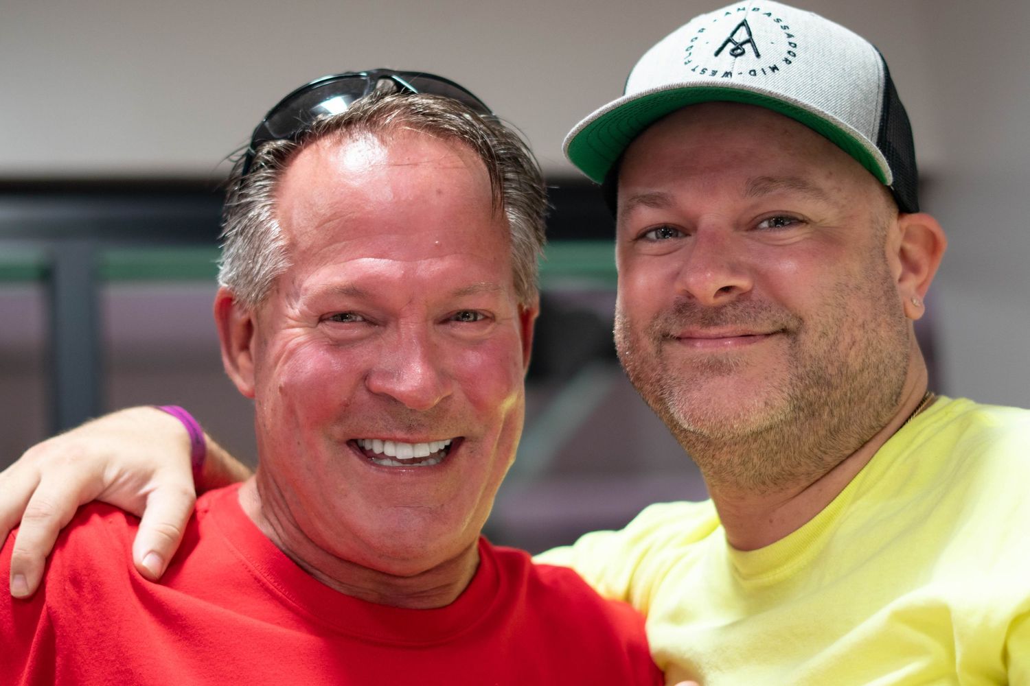 A series of portrait photos showing people wearing ball caps, t-shirts and casual attire in various poses.