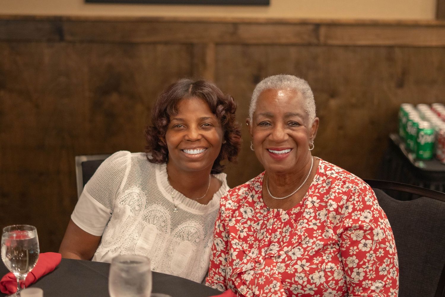 Warm gathering of family members sharing smiles and laughter at a social event.