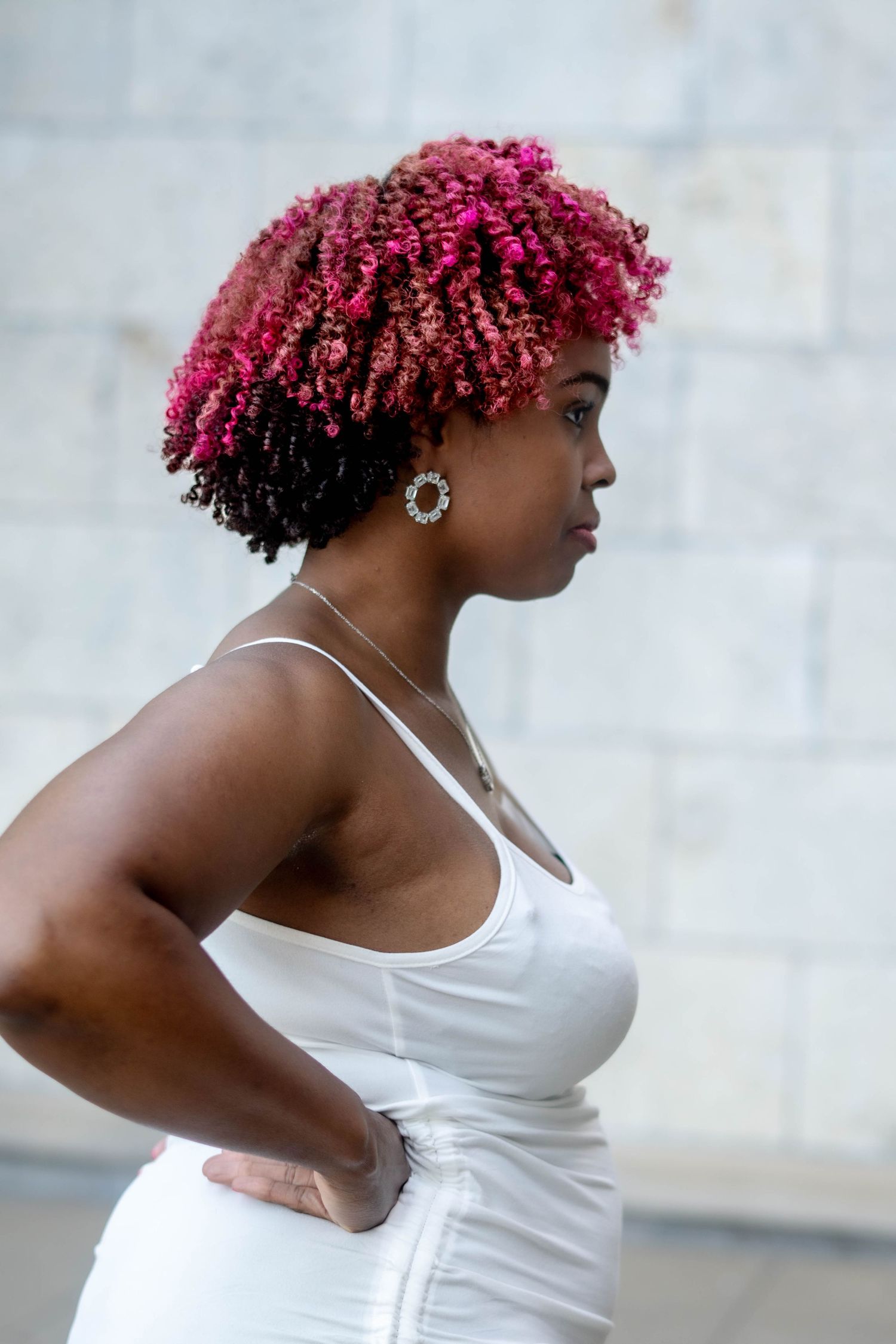 A sequence of dance poses shows a figure in a white tank top with vibrant pink hair against a light background.