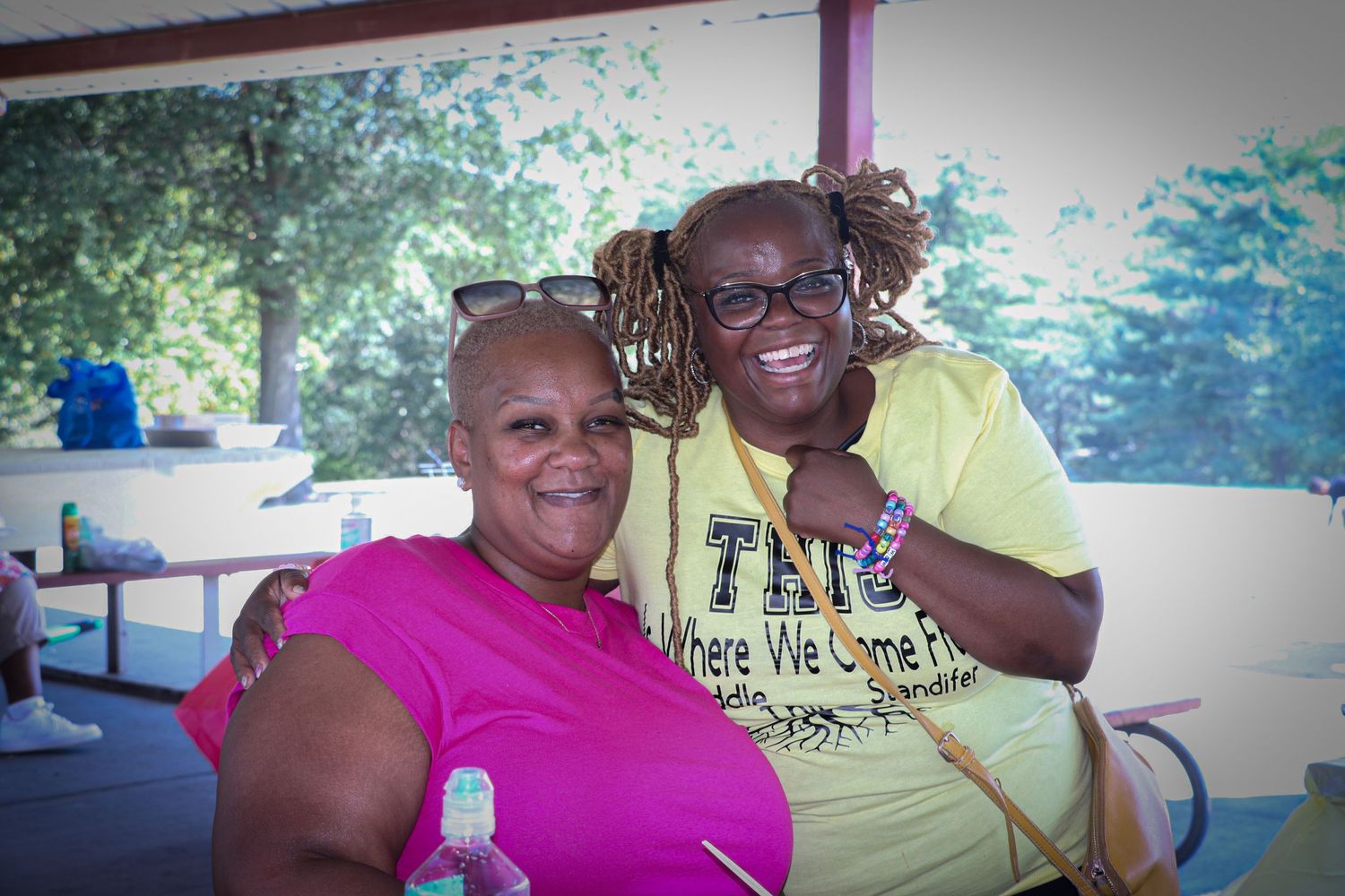 Outdoor summer gathering with people in bright casual clothing enjoying time together.