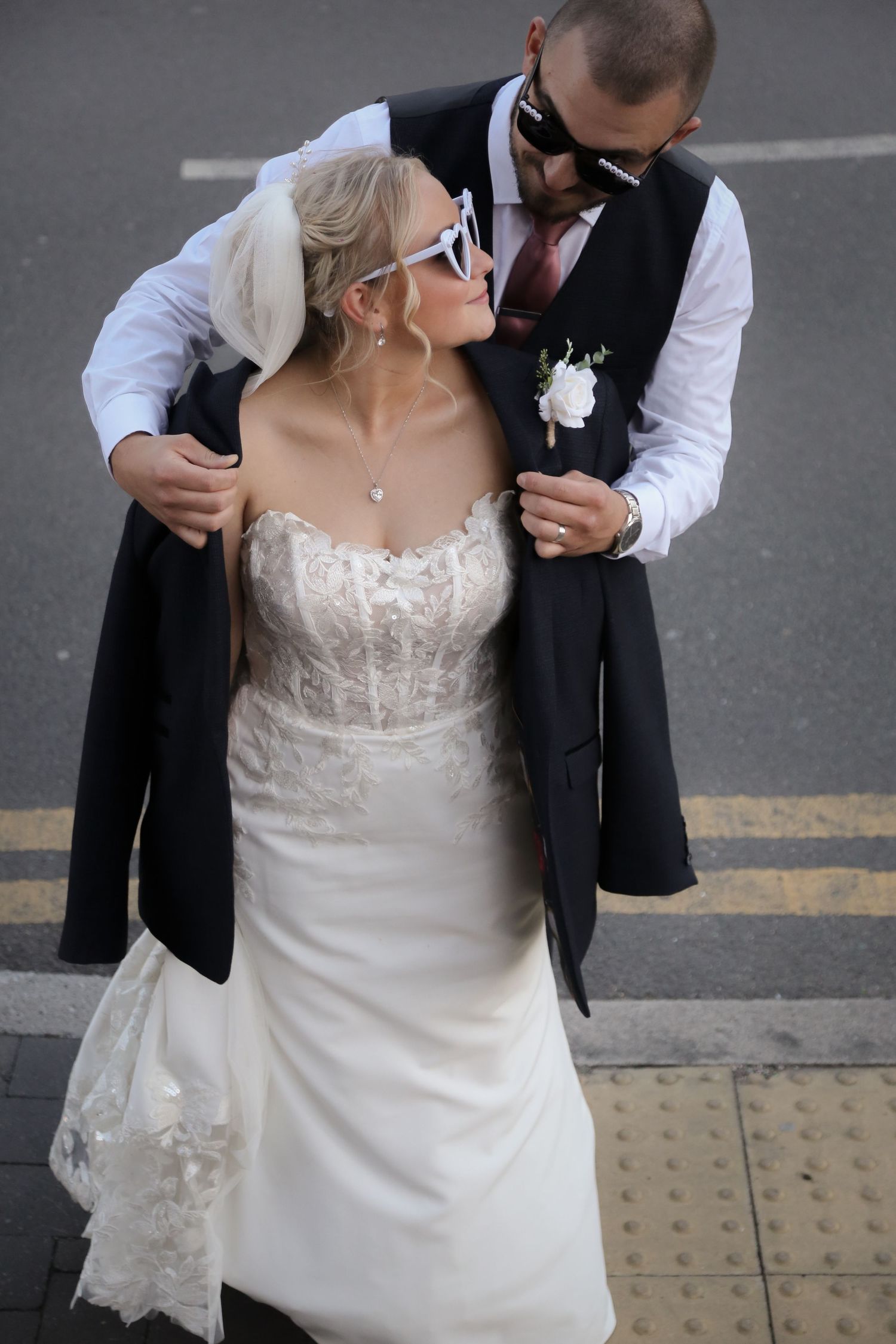 Groom putting jacket around bride's shoulders, Ruby Salmon Photography