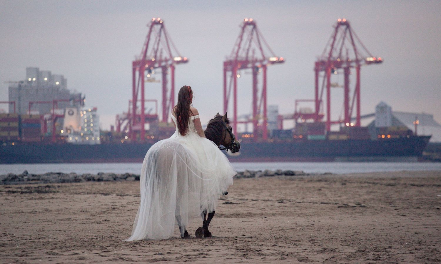 Bride riding on New Brighton beach, Wirral wedding photographer, Ruby Salmon Photography