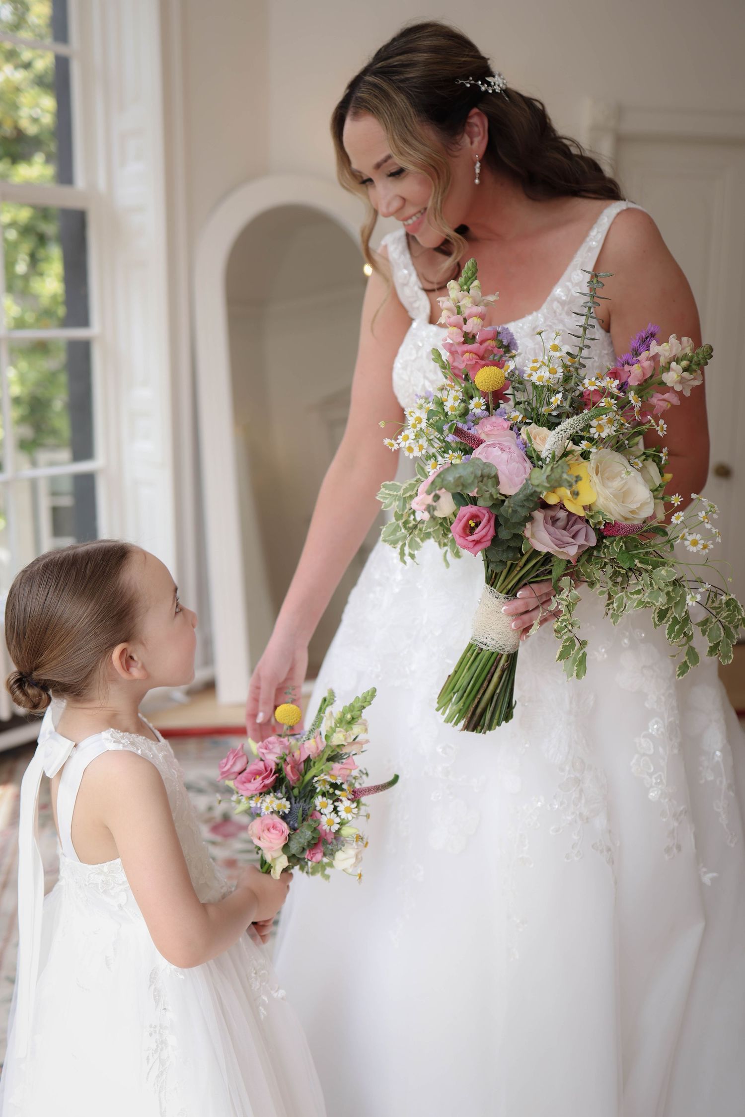 Bride and flower girl sharing a moment. Cheshire wedding photographer Ruby Salmon Photography