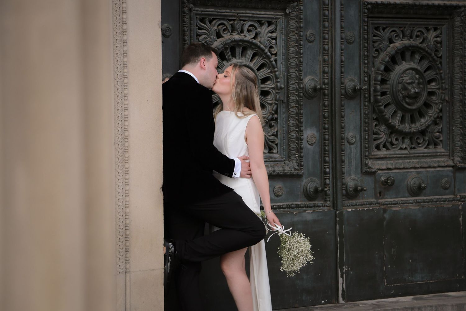Newlyweds share an intimate moment at the doorway of St Georges Hall Liverpool, Ruby Salmon Photography