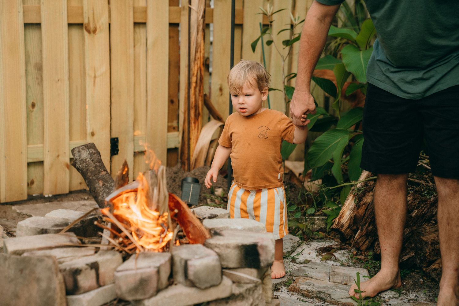 Family spending quality time together in wooden fenced backyard area.