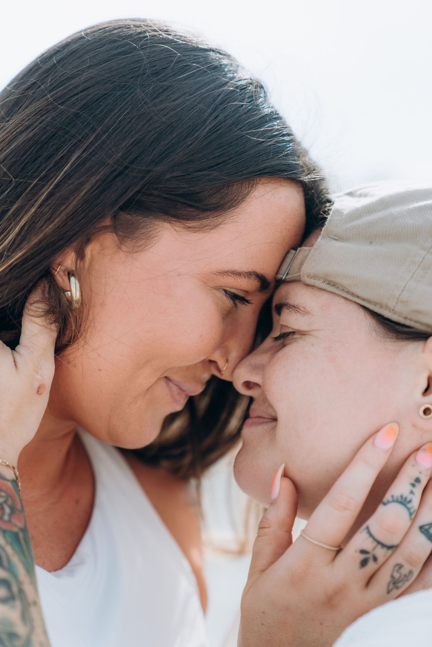 Close up intimate moment between couple with soft natural lighting.