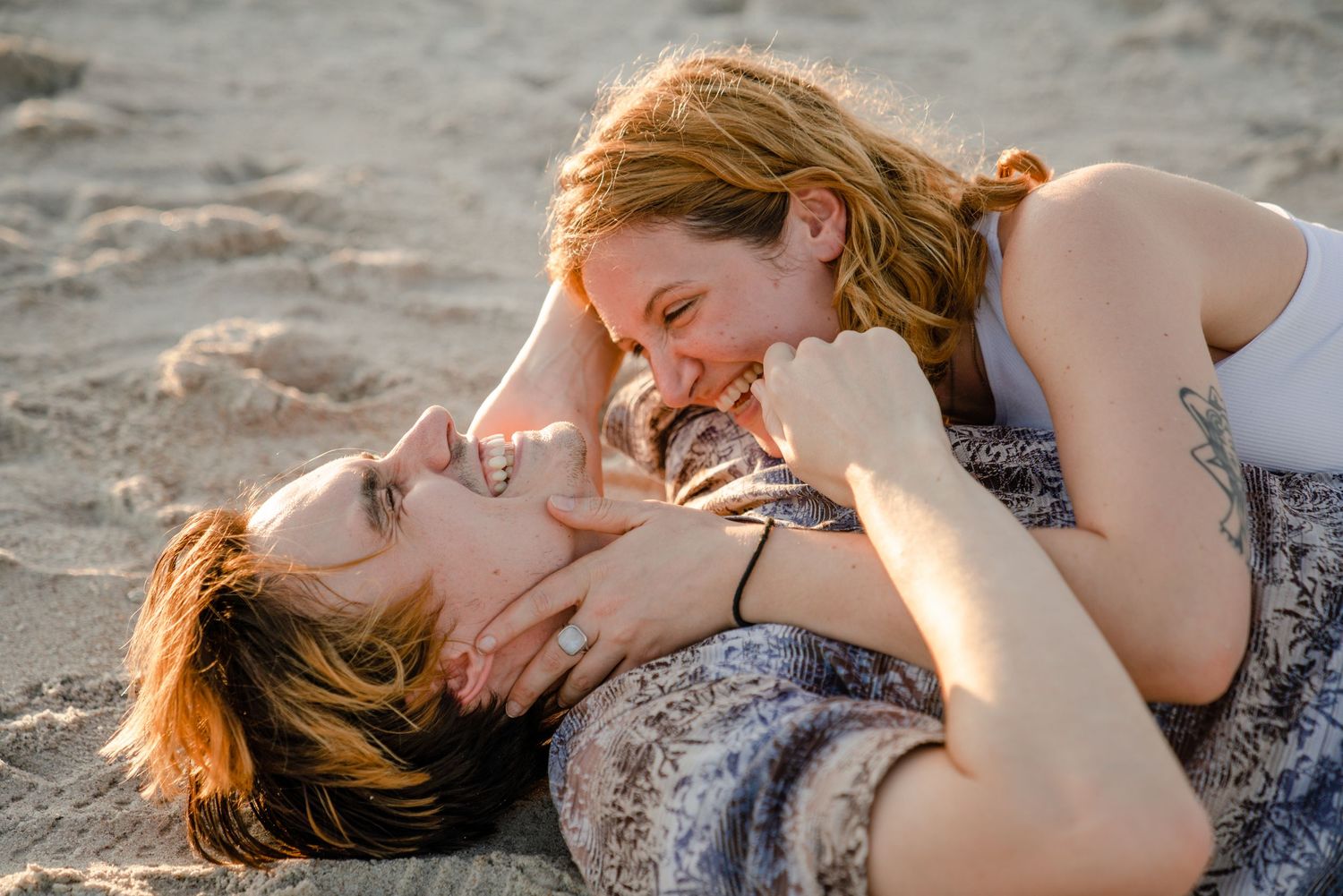 Tender beach moment captured during golden hour with soft natural lighting.