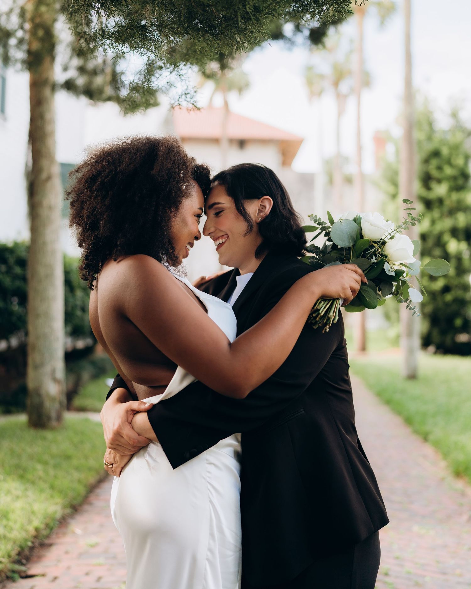A romantic wedding moment captured in a series of four intimate photos showing a couple in white and black attire.
